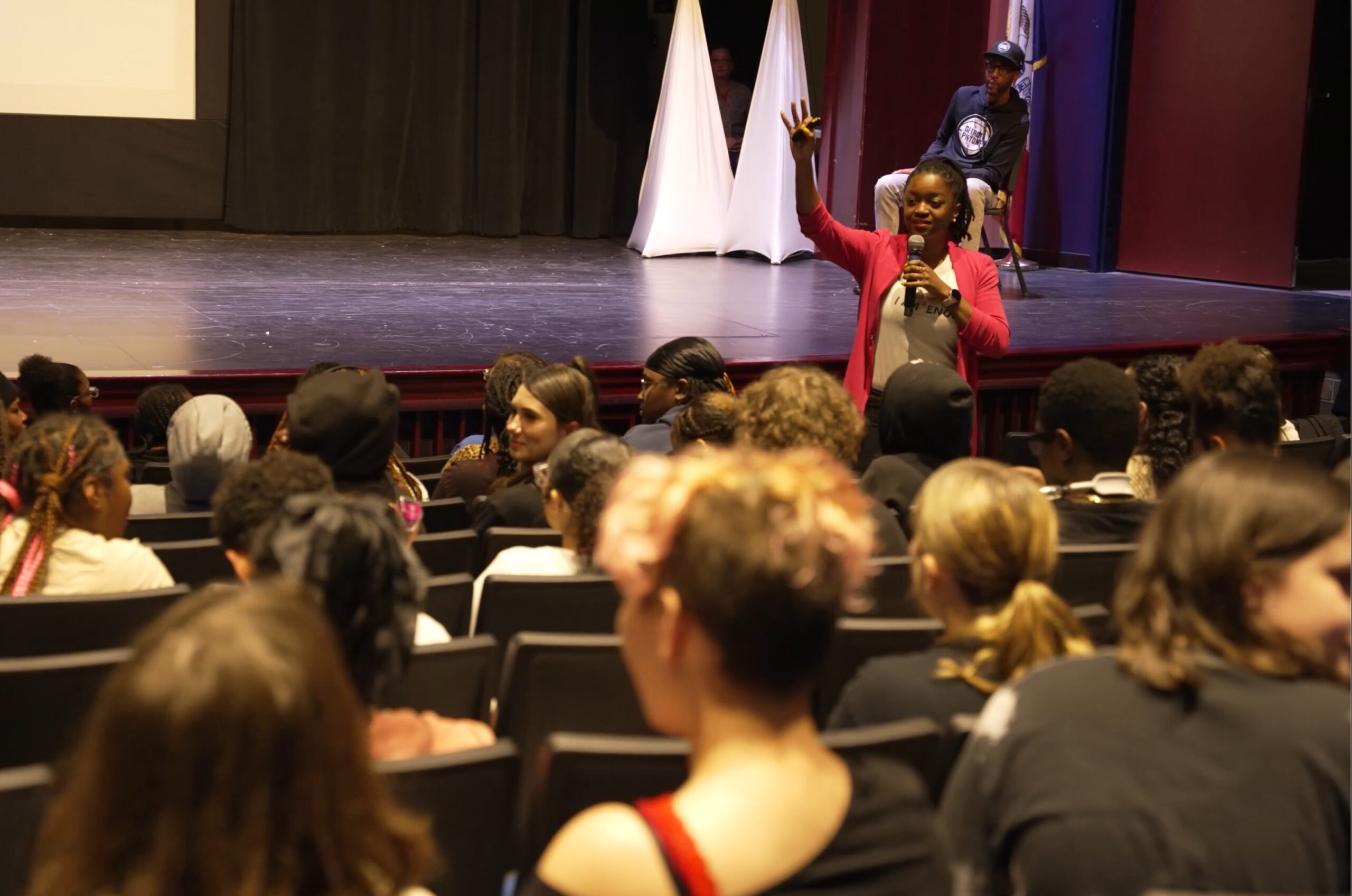 Woman giving a presentation to students.